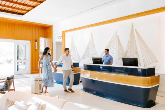 A couple arrives to the front desk at The Resort at Longboat Key Club