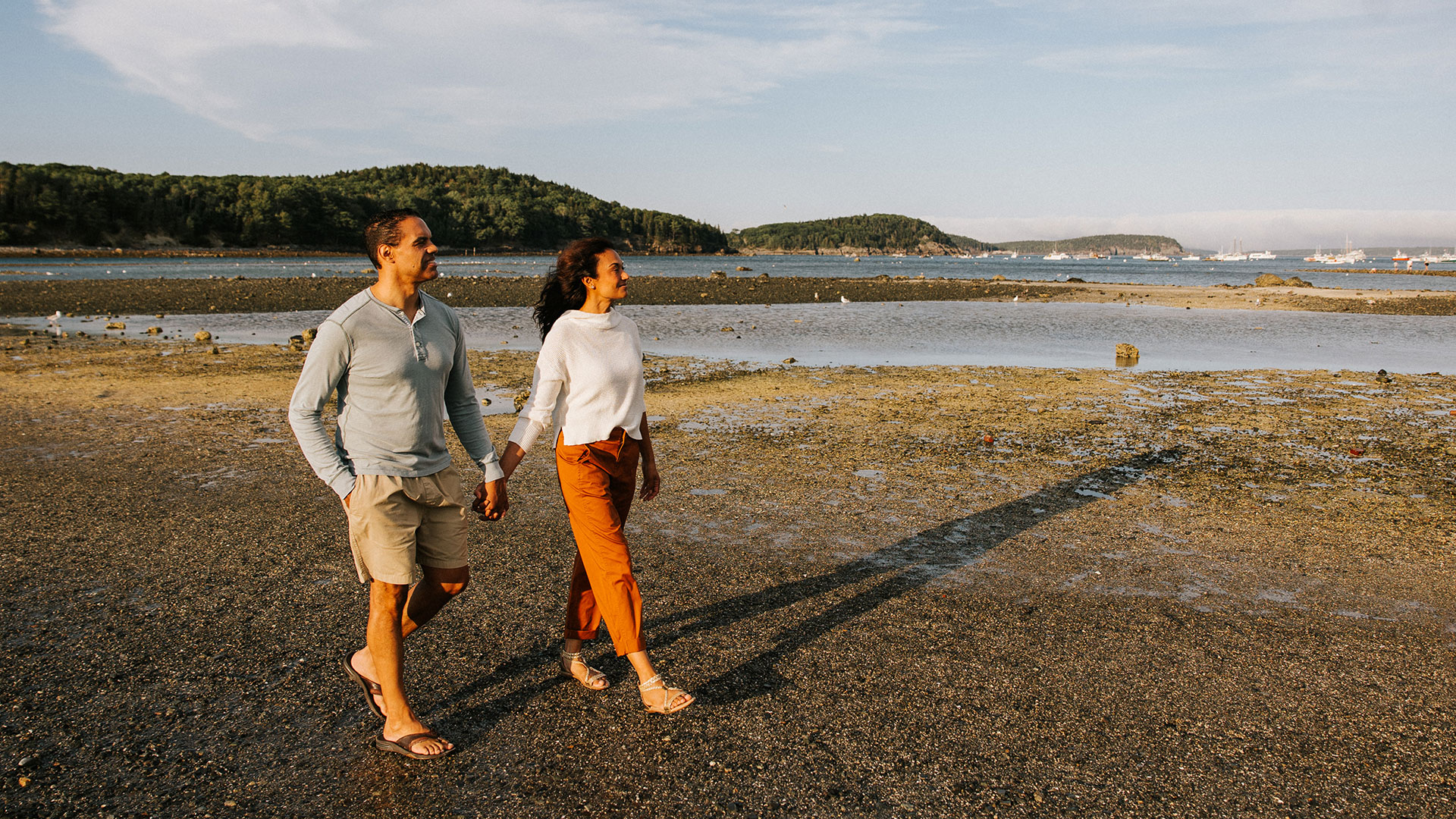 A couple strolls to Bar Island during low tide in Bar Harbor.