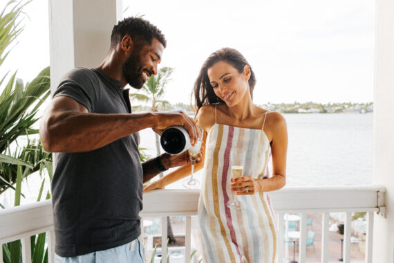 Couple on balcony at Opal Key Resort & Marina
