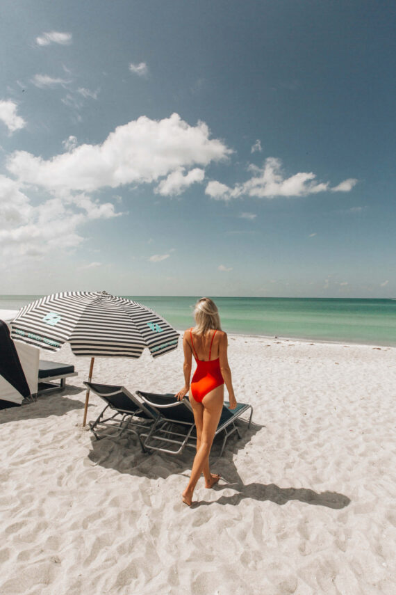 Woman on the beach at Zota Beach Resort. Courtesy of @LeagueTravels