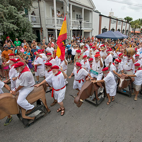 A horde of Hemingway lookalikes reenact the running of the bulls.