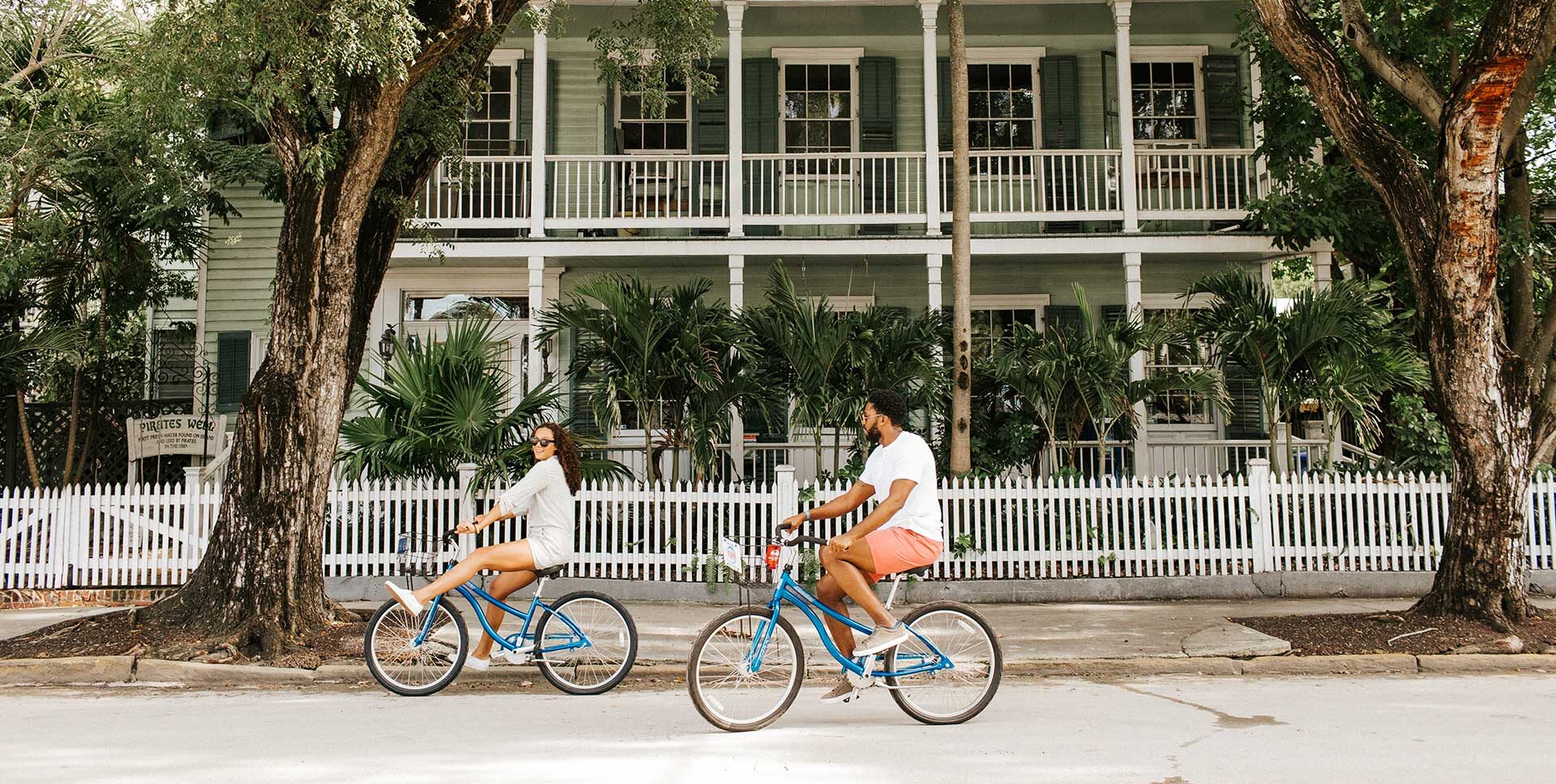 A couple bikes through a Key West neighborhood.