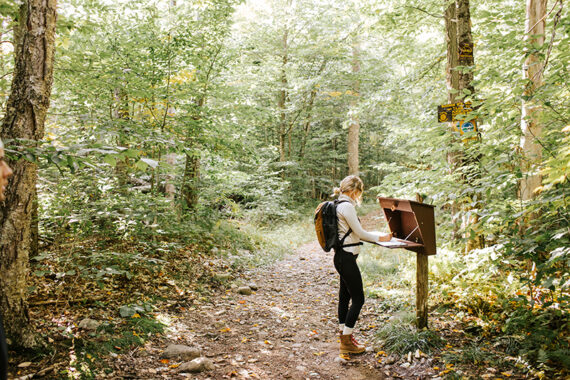 A woman hikes in Lake Placid.