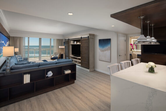 Living room of hotel suite featuring kitchen bar living room and ocean view