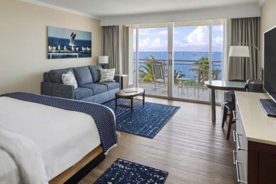 king bedroom with ocean front view and pull out sofa and table