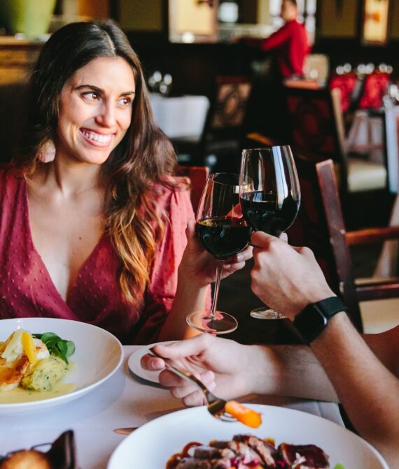 Sandpearl Couple at Dinner Toasting Red Wine