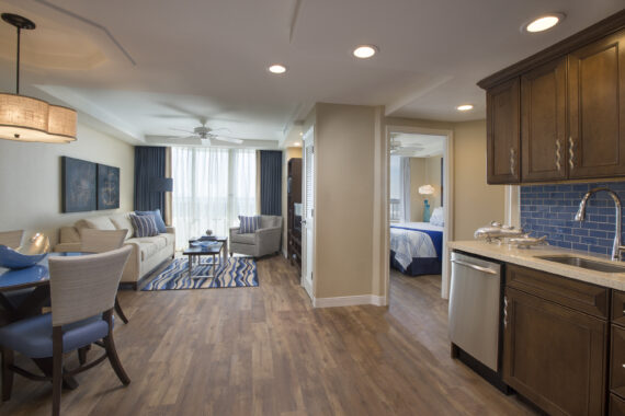 small living room and small view into one of the bedrooms