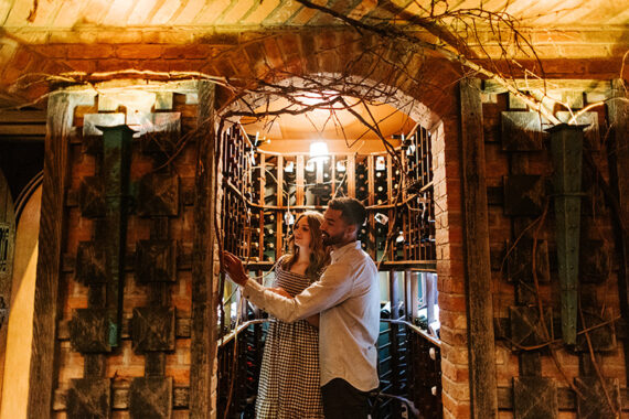 A couple peruses the bottles in the Wine Cellar at Lake Placid Lodge.