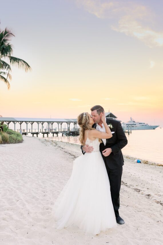 wedding couple kissing on the beach